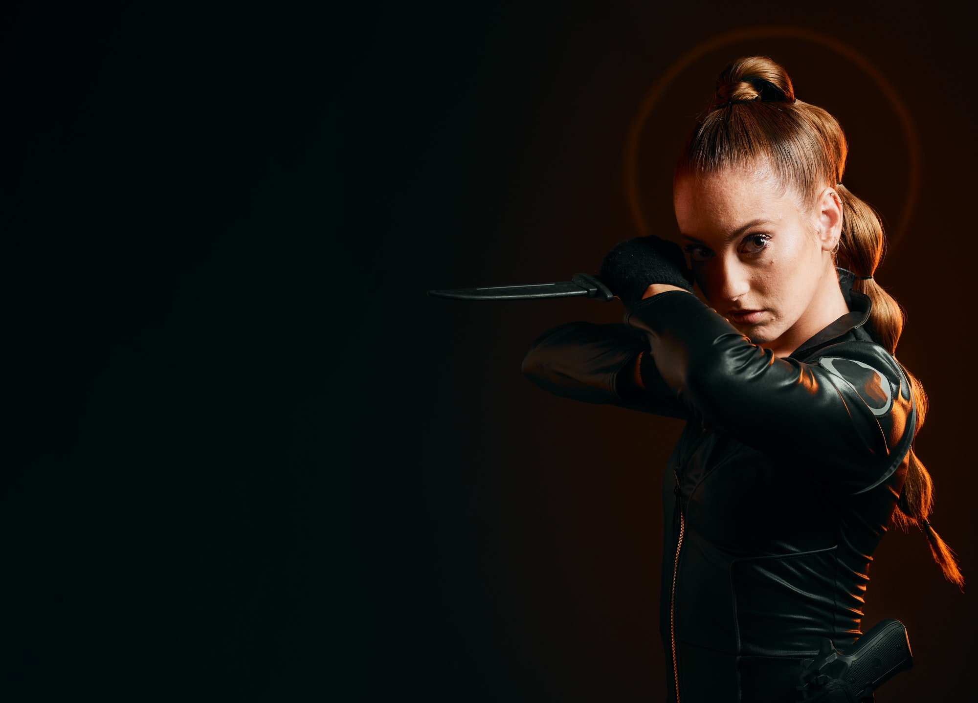 Woman, warrior and knife in studio with space for action, fight and safety from danger. Strong fema